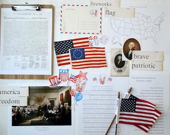 May include: A collection of patriotic themed classroom decorations, including a printed copy of the Declaration of Independence, a watercolor painting of fireworks, a small American flag, and a picture of George Washington. The text "America" and "Freedom" are printed on a wooden sign.