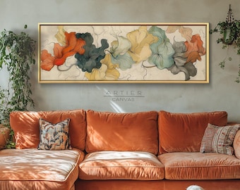 May include: An abstract floral painting in a gold frame hangs above an orange velvet sectional sofa. The artwork features red, teal, yellow, and gray organic shapes. A golden retriever dog rests on the patterned rug in front of the sofa.