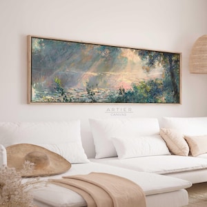 May include: A rectangular framed canvas art print showing a tranquil waterscape in soft blues, greens, and pinks. The artwork depicts a light-filled scene with trees and water lilies. The text "ARTIER CANVAS" is printed on the canvas.