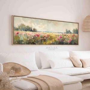 May include: A long, horizontal canvas painting depicting a field of pink wildflowers in a landscape setting. The painting has a soft, impressionistic style with a focus on the flowers and the surrounding greenery. The background features a hazy sky and distant trees.