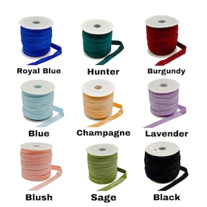 May include: Spools of elastic ribbon in various colors, including royal blue, hunter green, burgundy, blue, champagne, lavender, blush, sage, and black. Each spool is labeled with its color name.