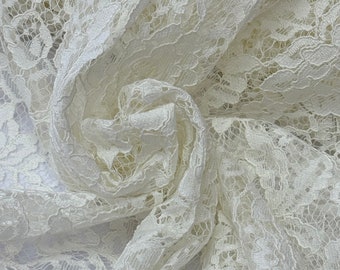 May include: White lace fabric with a delicate floral pattern. The fabric is soft and flowing, making it ideal for a variety of crafting projects.