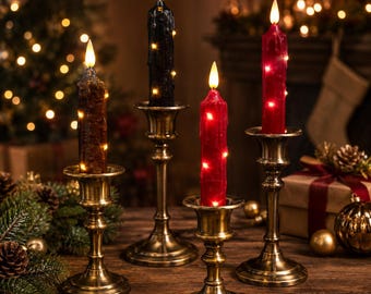 May include: Four LED taper candles in brown, black, and two shades of red, each featuring embedded fairy lights and a flame-shaped tip. The candles are held in individual brass-toned metal candle holders with a classic pedestal base design.