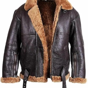 Può includere: Una giacca bomber in pelle marrone con collo e fodera in montone. La giacca ha una chiusura a zip, due tasche sul davanti e due tasche con zip sulle maniche.