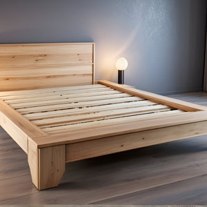 May include: A wooden platform bed frame with a slatted base and a headboard. The bed frame is made of natural wood and has a simple, modern design.