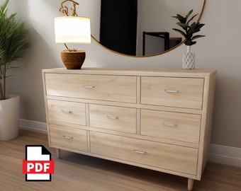 May include: A light wood dresser with six drawers and silver drawer pulls. The dresser has a modern design with slightly angled legs. The dresser is in a room with a mirror and a lamp on a side table.