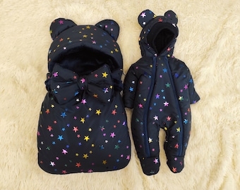 Autumn and winter set for newborns. Baby sleeping bag and rainwear fabric romper for a newborn