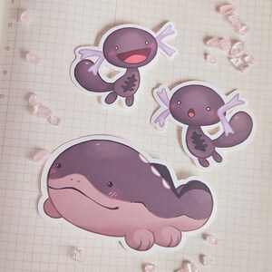 May include: Three cartoon stickers featuring axolotls. The stickers are on a white gridded background. The axolotls are purple, pink, and gray with white spots. The axolotls have big eyes and smiles.