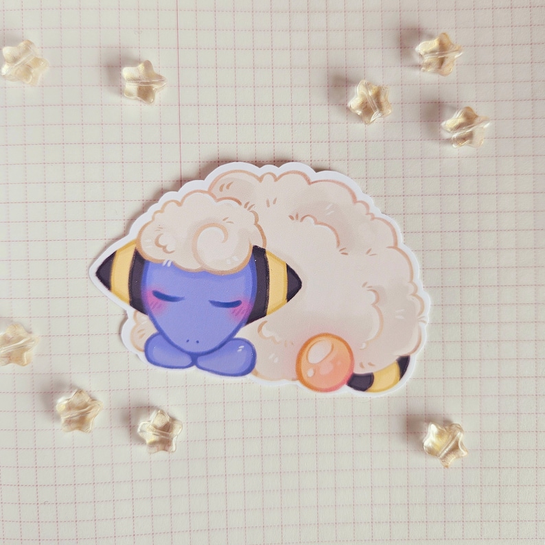 May include: A sticker of a blue and yellow Pokemon character with a white fluffy body, sleeping with its eyes closed. The character has a pink blush on its cheeks and a yellow and black striped pattern on its body.