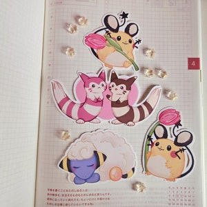 May include: A set of six illustrated stickers featuring cartoon characters from the Pokemon franchise. The stickers are printed on white paper with a glossy finish. The characters include a pink and white Eevee, a brown and white Eevee, a yellow Pikachu, a brown and white Vaporeon, a blue and white Snorlax, and a yellow and brown Pichu.