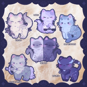 May include: Six cartoon cat illustrations, each representing a zodiac sign. The cats are in various colours, including white, purple, and blue, with constellations and zodiac names like "Virgo" and "Libra" displayed.