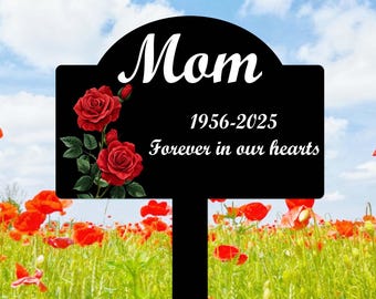 May include: Black metal garden stake with a sign that reads "Mom 1956-2025 Forever in our hearts". The sign has a red rose design.