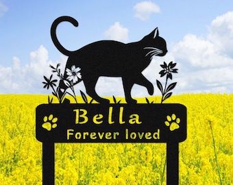 May include: Black metal silhouette of a cat with flowers, a sign that reads "Bella Forever loved" with paw prints on either side.