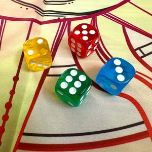 May include: Four dice in different colors: red, yellow, green, and blue. Each die has white dots on its faces.