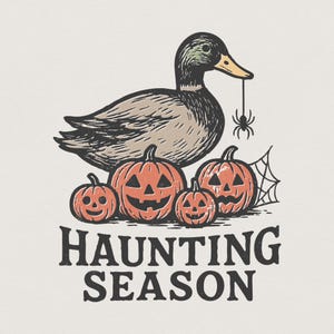 May include: A retro illustration shows a duck holding a spider, with carved orange pumpkins below. The text "HAUNTING SEASON" is printed beneath the pumpkins, creating a Halloween-themed design.