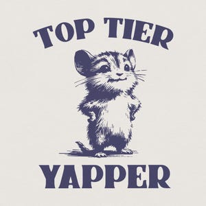 May include: A navy blue graphic featuring a smiling mouse with its paws on its hips. The text "TOP TIER" arches above the mouse, and "YAPPER" is printed below. The design has a vintage, hand-drawn aesthetic.