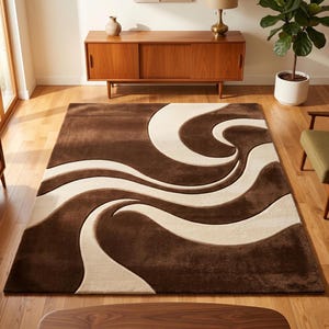 Top-down view of a hand-tufted fine premium wool rug by SHAH RUGS. The modern abstract design features bold, flowing 3D carved waves in a contrasting two-tone palette of deep chocolate brown and creamy beige. Styled flat against a clean white background.