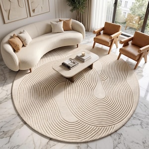 May include: A large, circular, cream-colored area rug featuring a textured, raised pattern of concentric, flowing, wave-like lines that create a continuous, organic design across the entire surface of the floor covering.