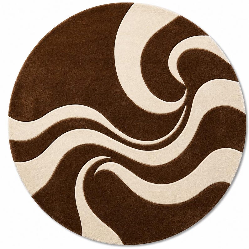 May include: A round rug with a brown and cream-colored swirling pattern. The rug has a soft, plush texture and a modern design. The brown sections are a darker shade, contrasting with the lighter cream-colored waves.