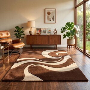 May include: A brown and cream-colored area rug with a wavy design. The rug is rectangular and has a plush texture. The room also features a brown leather chair, a wooden cabinet, and a large potted plant.