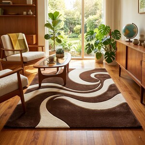 May include: A brown and cream-colored area rug with a swirling pattern dominates the room. The rug is rectangular and features a repeating wave design in shades of brown and cream. The room has mid-century modern furniture and large plants.