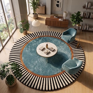 May include: A large circular area rug featuring a central blue textured section, a burnt orange border, and a wide outer ring with black and white radial stripes. A round white marble coffee table sits in the center with books on top.