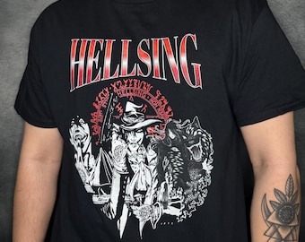 May include: Black t-shirt with a red "Hellsing" graphic. The graphic features a character with a hat and a wolf, surrounded by a circle of text.