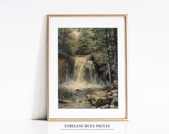 May include: A framed print featuring a waterfall scene in a forest. The artwork has a vintage aesthetic with muted greens, browns, and whites. The frame is gold. The text "TIMELESS HUES PRINTS" is at the bottom.
