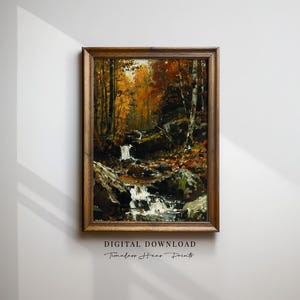 Puede incluir: Pintura enmarcada de un paisaje de cascada en un bosque otoñal. La obra utiliza una paleta cálida de naranjas, marrones y verdes, con pinceladas visibles. El marco es de madera.