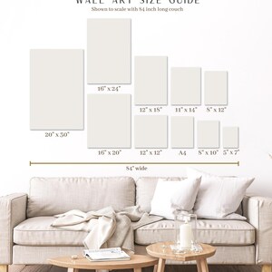May include: Wall art size guide showing various rectangular canvas sizes, including 20" x 30", 16" x 24", and 12" x 18", displayed above a beige couch that is 84 inches wide. The guide is shown to scale.