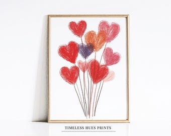 Puede incluir: Una impresión enmarcada de un ramo de globos en forma de corazón rojo, rosa, naranja y morado con una cuerda negra. La impresión tiene el texto "TIMELESS HUES PRINTS" en la parte inferior.