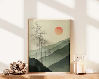 May include: A framed landscape art print featuring a minimalist design of mountains, trees, and a setting sun in shades of green, beige, and orange. A glass candle holder with a lit candle is next to the print.