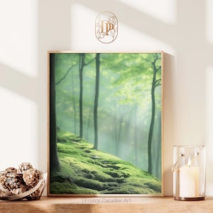 May include: A framed art print depicts a lush green forest scene with tall trees and a mossy hillside. The artwork is displayed on a wooden surface, next to a glass candle holder and a bowl of pinecones. The text "Dreamy Paradise Art" is visible.
