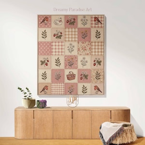 May include: A framed wall art piece featuring a patchwork design with squares of various patterns and illustrations. The artwork includes images of birds, strawberries, flowers, and a swan, in shades of pink, beige, and brown. The text "Dreamy Paradise Art" is at the top.