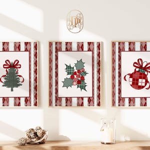 May include: Three framed Christmas-themed prints. Each print features a different design: a Christmas tree, holly with berries, and a decorative ornament. The frames have a red and white striped and diamond pattern.