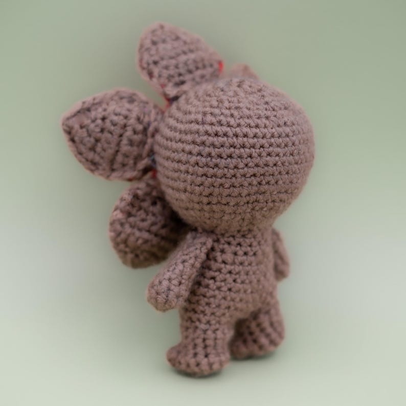 Pode incluir: Um brinquedo de pel&uacute;cia Demogorgon feito &agrave; m&atilde;o, de croch&ecirc;, em uma cor marrom suave. O brinquedo apresenta uma cabe&ccedil;a redonda, bra&ccedil;os e pernas pequenos e uma cabe&ccedil;a distinta em forma de p&eacute;tala. A pel&uacute;cia &eacute; feita com pontos de croch&ecirc; vis&iacute;veis.