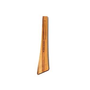 May include: A light brown wooden kitchen utensil. The tool has a long, slender handle with two vertical grooves and a wider, angled end. The text "Willow Tree Decor" is printed on the handle.