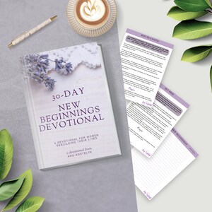 May include: A white book with a purple floral design on the cover. The title is "30-Day New Beginnings Devotional: A Devotional for Women Rebuilding Their Lives" with the author's name "Ang Kostelyk" below.