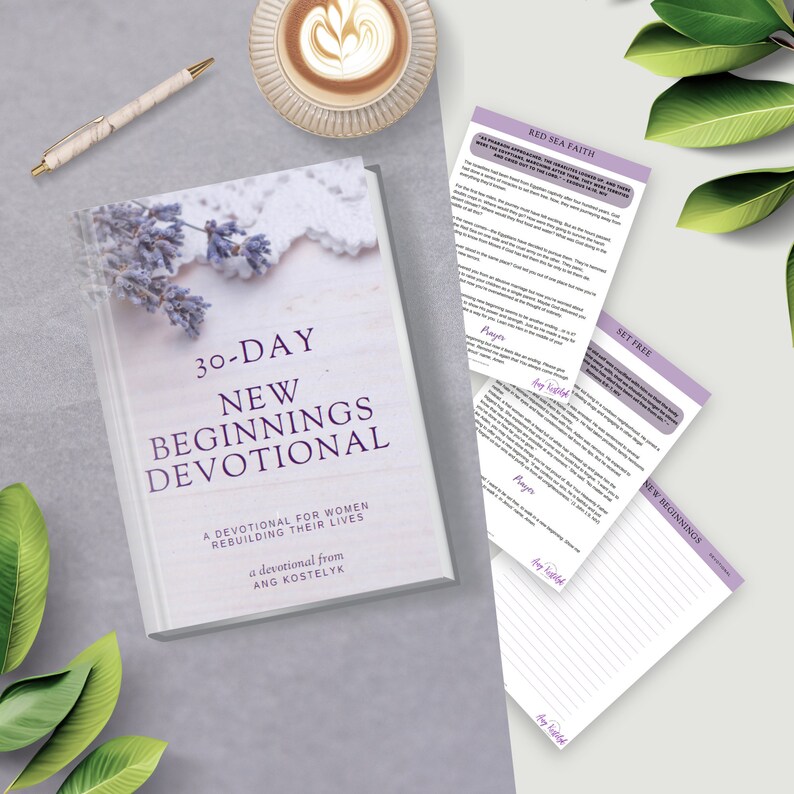 May include: A white book with a purple floral design on the cover. The title is "30-Day New Beginnings Devotional: A Devotional for Women Rebuilding Their Lives" with the author's name "Ang Kostelyk" below.