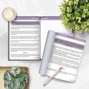 May include: A close-up of two open pages from a journal with the text "Red Sea Faith" and "New Beginnings" on the top of each page. The pages are filled with handwritten text and inspirational quotes about faith and new beginnings. The text includes the Bible verse "For we knew that our old self was crucified with him so that the body ruled by sin might be done away with, that we should no longer be slaves to sin&mdash;because anyone who has died has been set free from sin." - Romans 6:6-7, NIV.