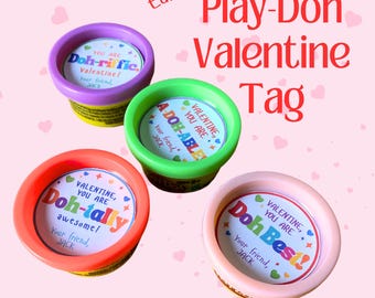 May include: Four small containers of Play-Doh with Valentine's Day themed labels. The labels have different colours and say "You are Doh-riffic", "You are A-Doh-Able", "You are Doh-tally awesome", and "You are Doh Best!"