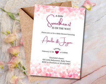 May include: A pink and white baby shower invitation with a heart design. The text reads "A little Sweetheart is on the way!"  Please join us for a Baby Shower honoring Amelia & Jayson. Saturday, February 12th at 3:00PM. Charlotte's home, 456 Little Babystreet, Baby Town. RSVP to Charlotte at 321.654.0987.