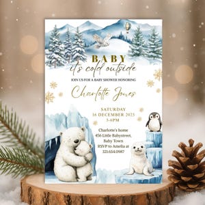 May include: Baby shower invitation with a winter theme. The invitation features a watercolour illustration of a snowy landscape with polar bears, a penguin, and a seal. Text includes "Baby, it's cold outside" and details for Charlotte Jones' baby shower.