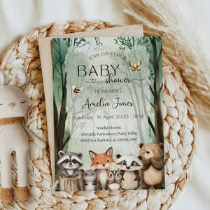May include: A baby shower invitation with a forest theme. The invitation reads "Join us for a Baby Shower Honoring Amelia Jones." The invitation features illustrations of woodland animals, including a raccoon, fox, and bear. The date and time are also included.