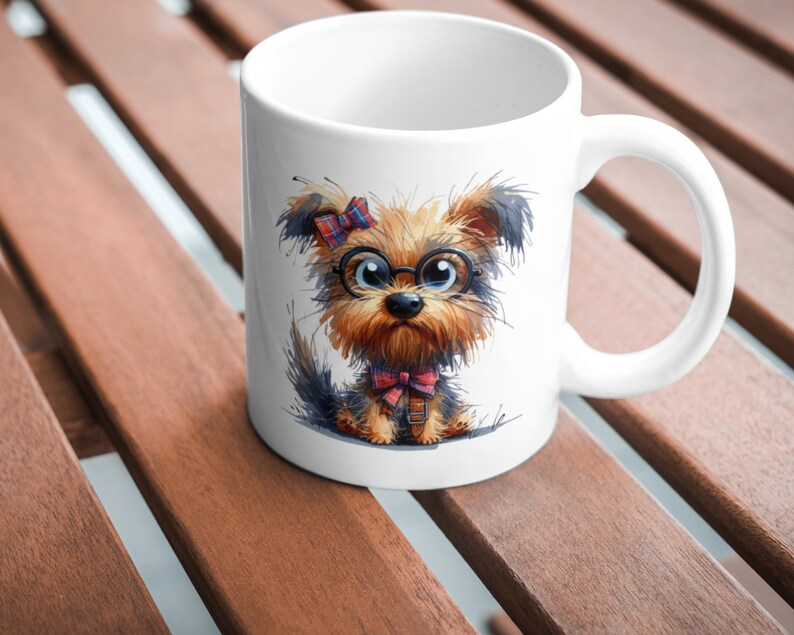 May include: White ceramic mug with a cartoon illustration of a Yorkshire Terrier wearing glasses and a bow tie. The dog has brown and black fur and a pink bow in its hair.