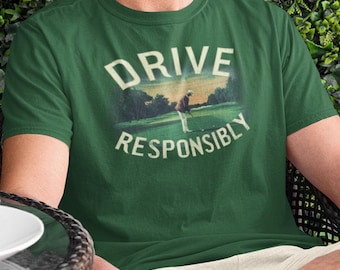 May include: Green t-shirt with a vintage-style graphic of a golfer on a green golf course. The text "DRIVE RESPONSIBLY" is printed below the image.