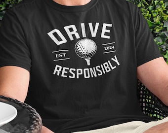 May include: Black t-shirt with a white graphic that says "DRIVE RESPONSIBLY" with a golf ball and the text "EST 2024".