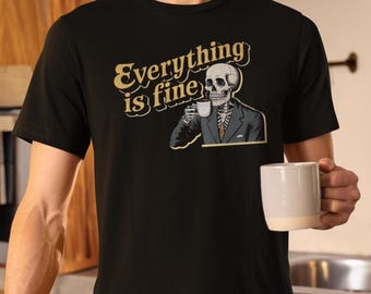 May include: Black t-shirt with a skeleton wearing a suit and holding a cup of coffee. The text "Everything is fine" is printed in yellow on the shirt.