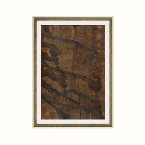 May include: A rectangular framed wall art piece featuring an abstract composition with dark brown and black organic, fluid shapes layered over a textured, weathered tan background, enclosed within a decorative gold-toned metallic frame.