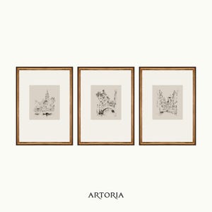 May include: Set of three framed black and white ink drawings of cityscapes. Each drawing is framed in a simple gold frame.